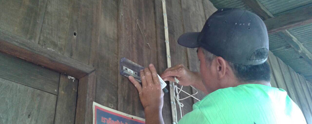 TakNet. A villager installing a wireless router in its home to have an Internet access